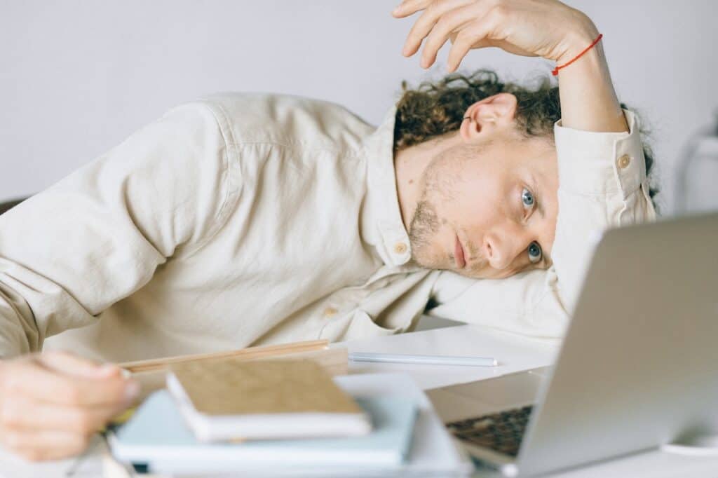 Young man feeling burnt out from working too hard