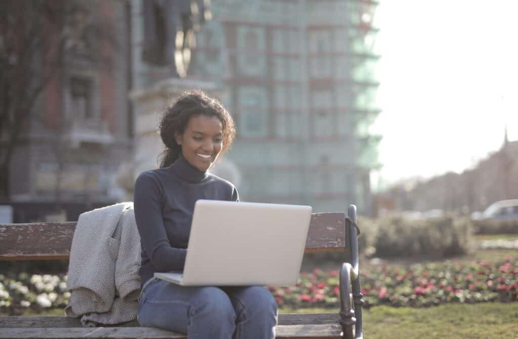 Woman working remotely outside while traveling