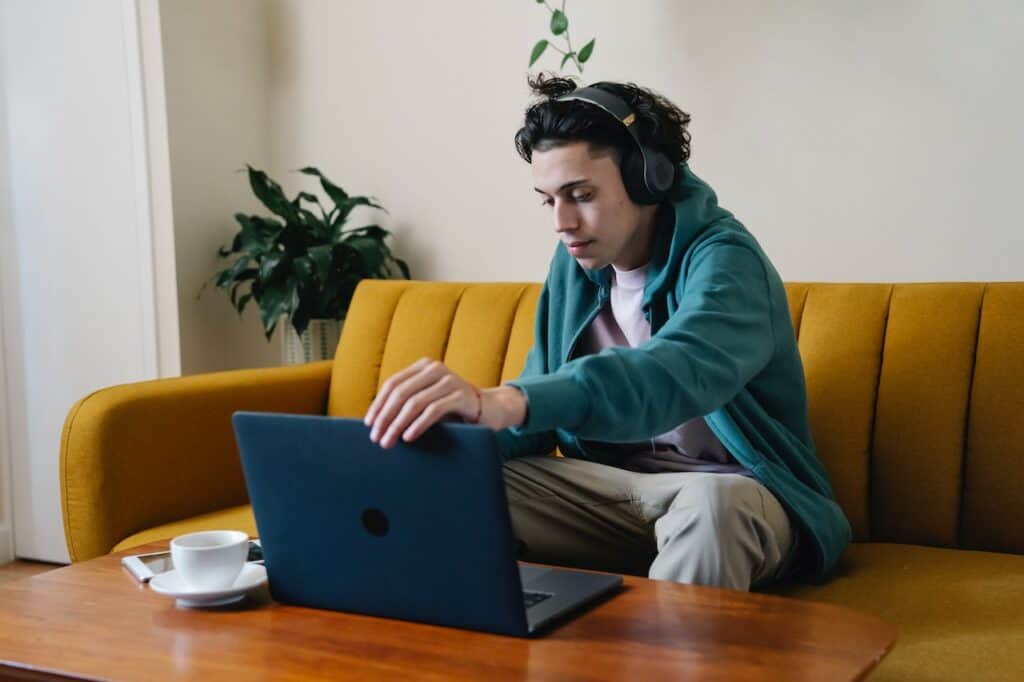Person enjoying the benefits of working from home on their couch