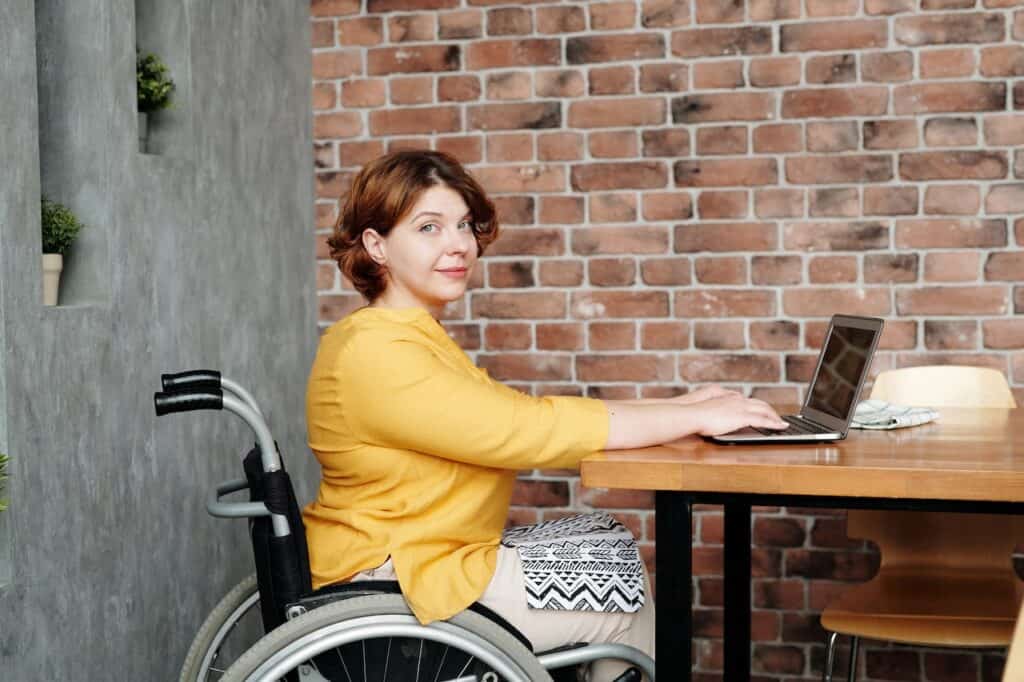 Person in wheelchair enjoying the benefits of work-from-home inclusivity and accessibility