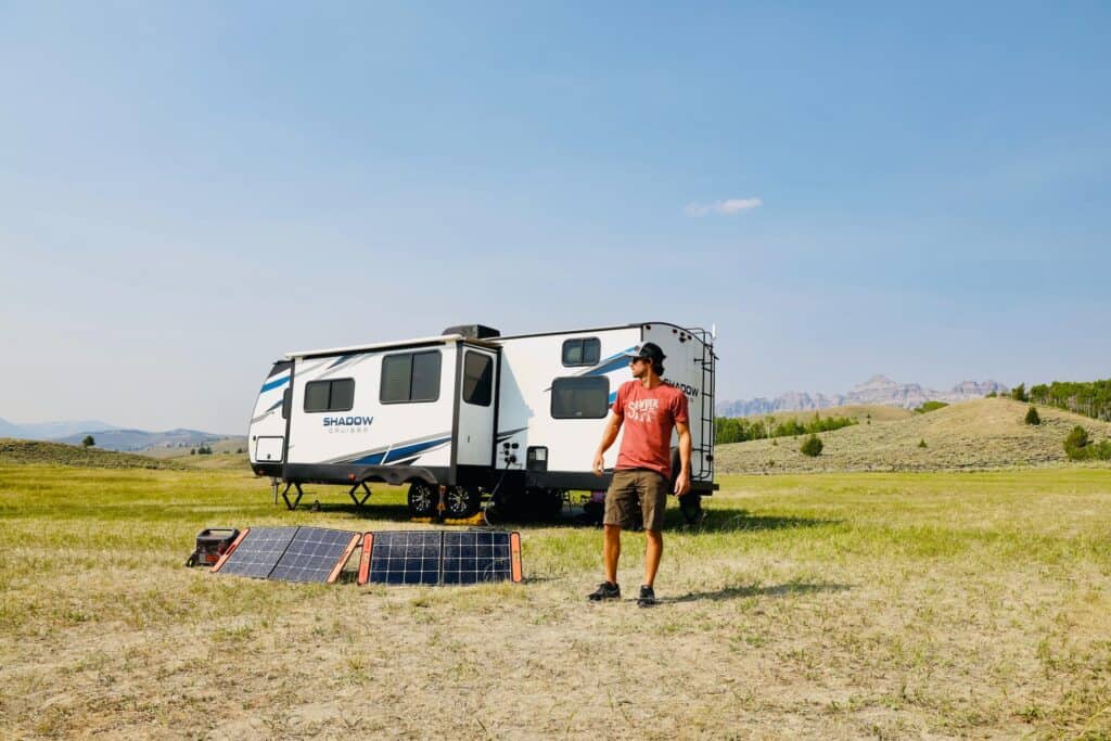 Portable solar panels set up outside a remote worker's RV 