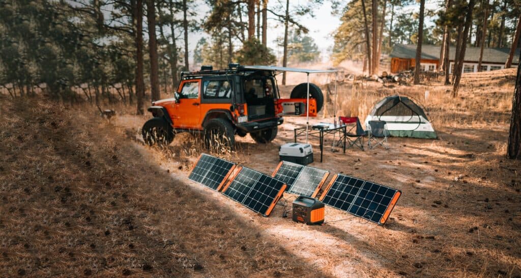 A portable solar panel setup outside for camping while working remotely