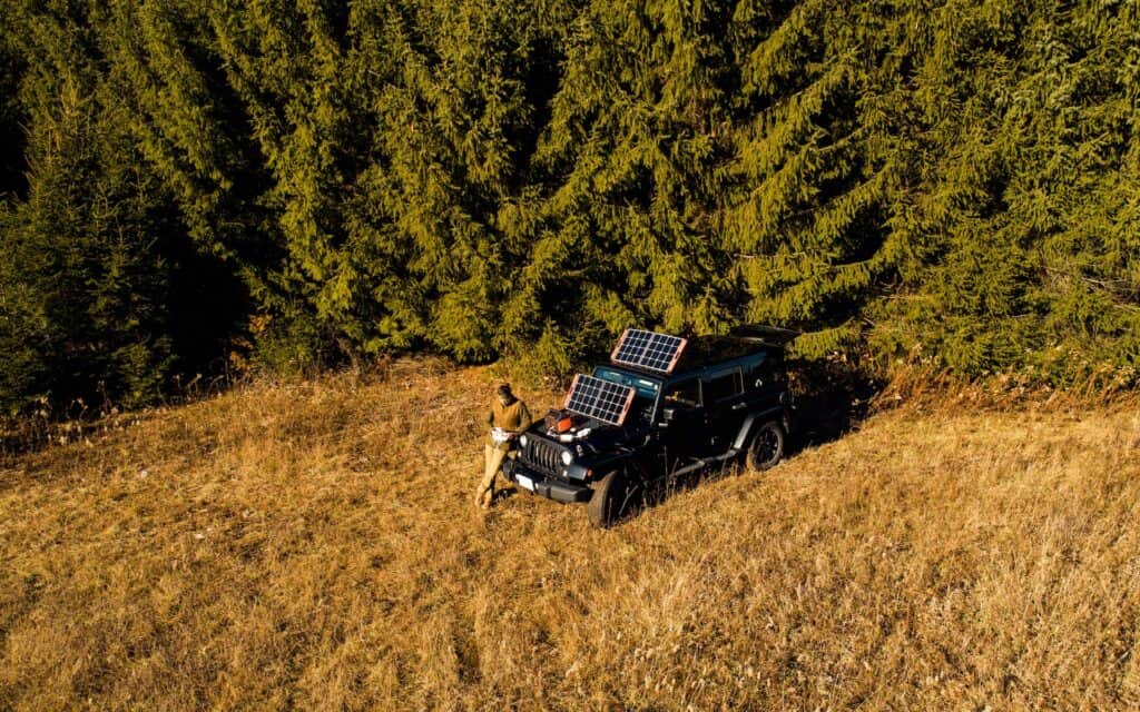 A digital nomad's portable solar panels set up on a vehicle