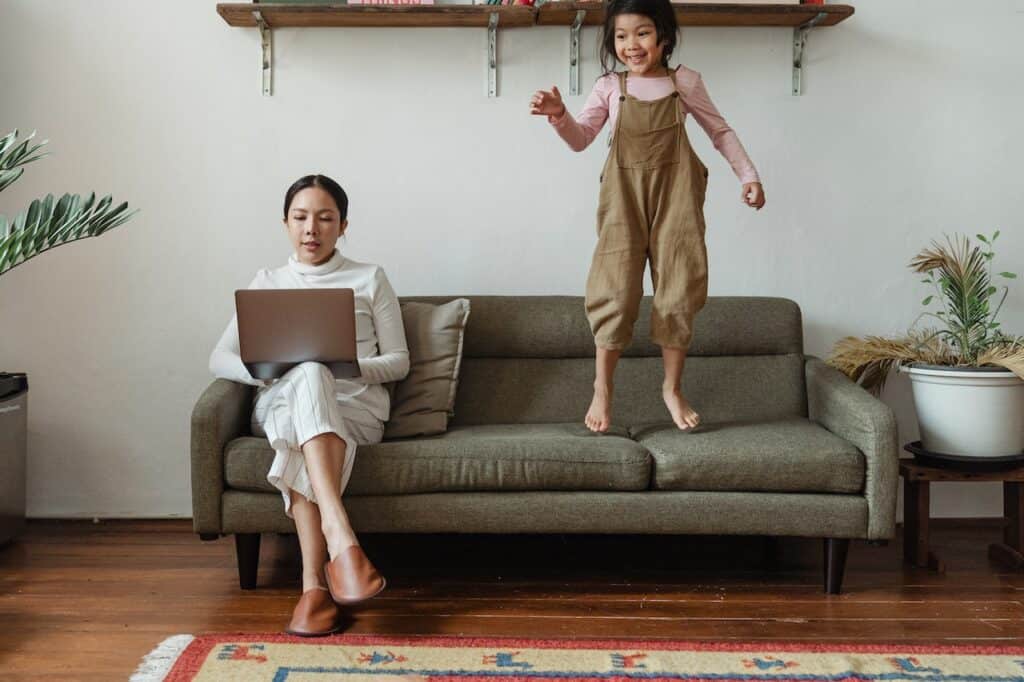 A remote worker with kids working from home using WFH productivity tips