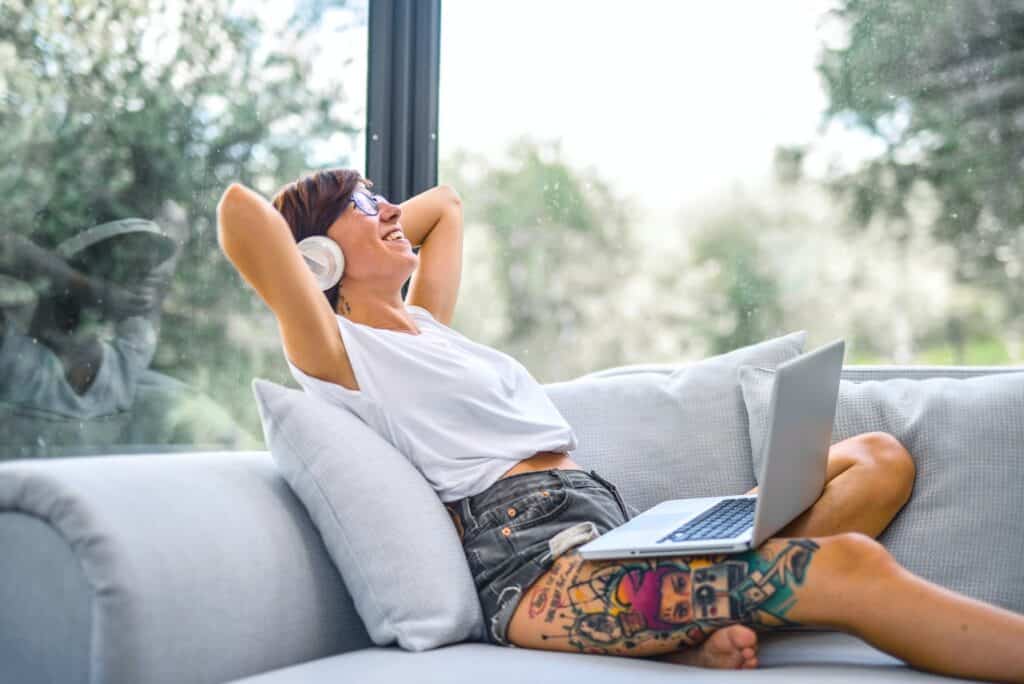 A remote worker working from home on their couch