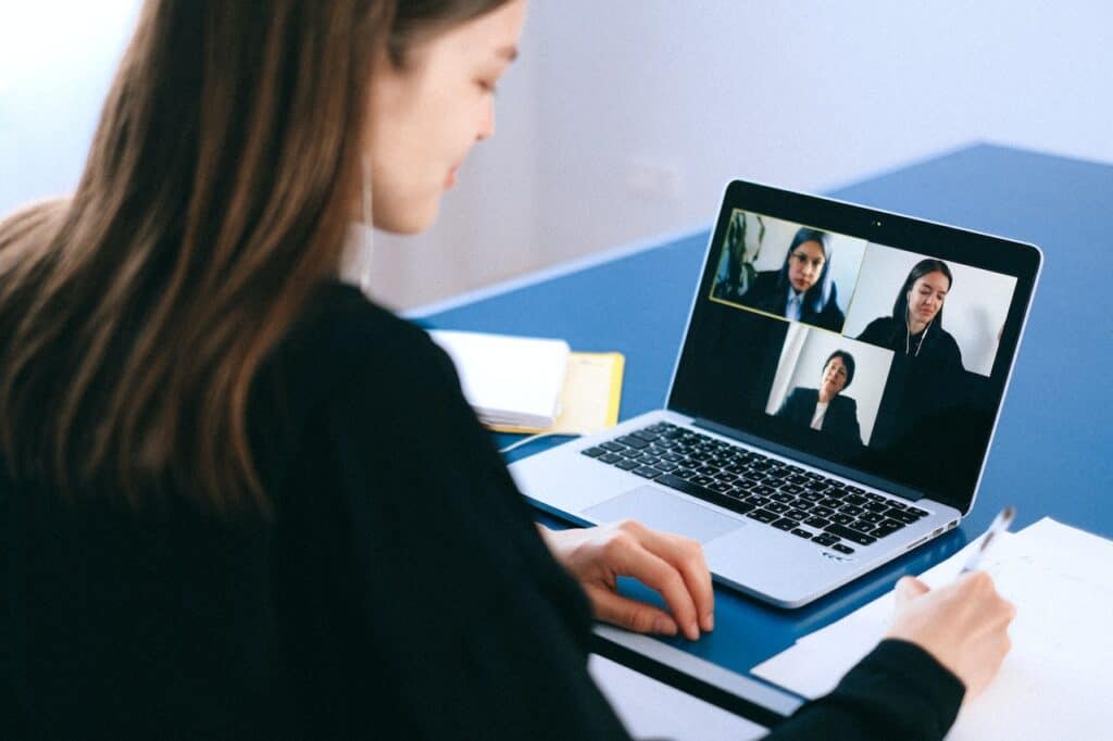 A remote worker communicating with teammates via video conference call