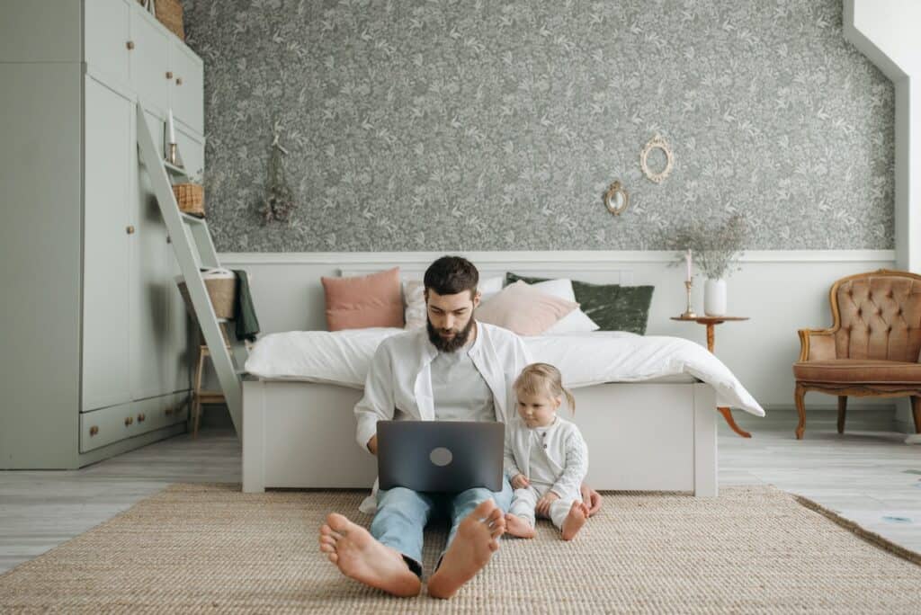 Employee working from home with a baby for a top remote-first company